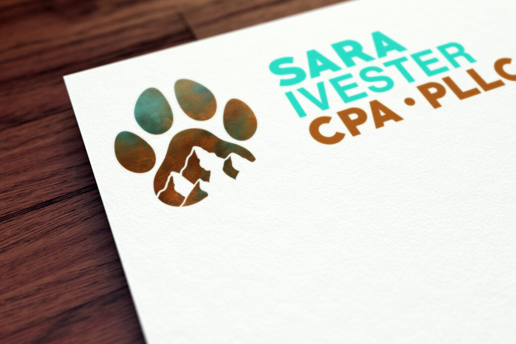 A white paper with a logo that combines blue and brown is placed on dark brown wood.